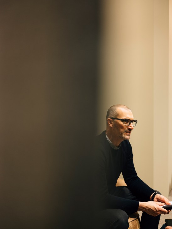 Cristiano Pigazzini, studio manager at Note Design Studio in Sweden, seated and wearing glasses against a minimalist background.
