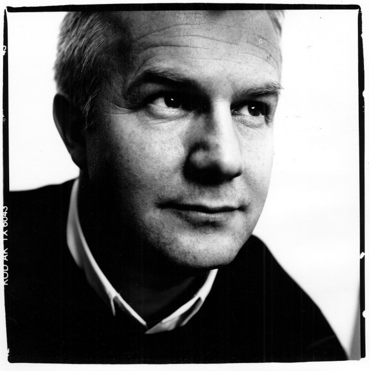 Black and white portrait photograph of a man in business attire.