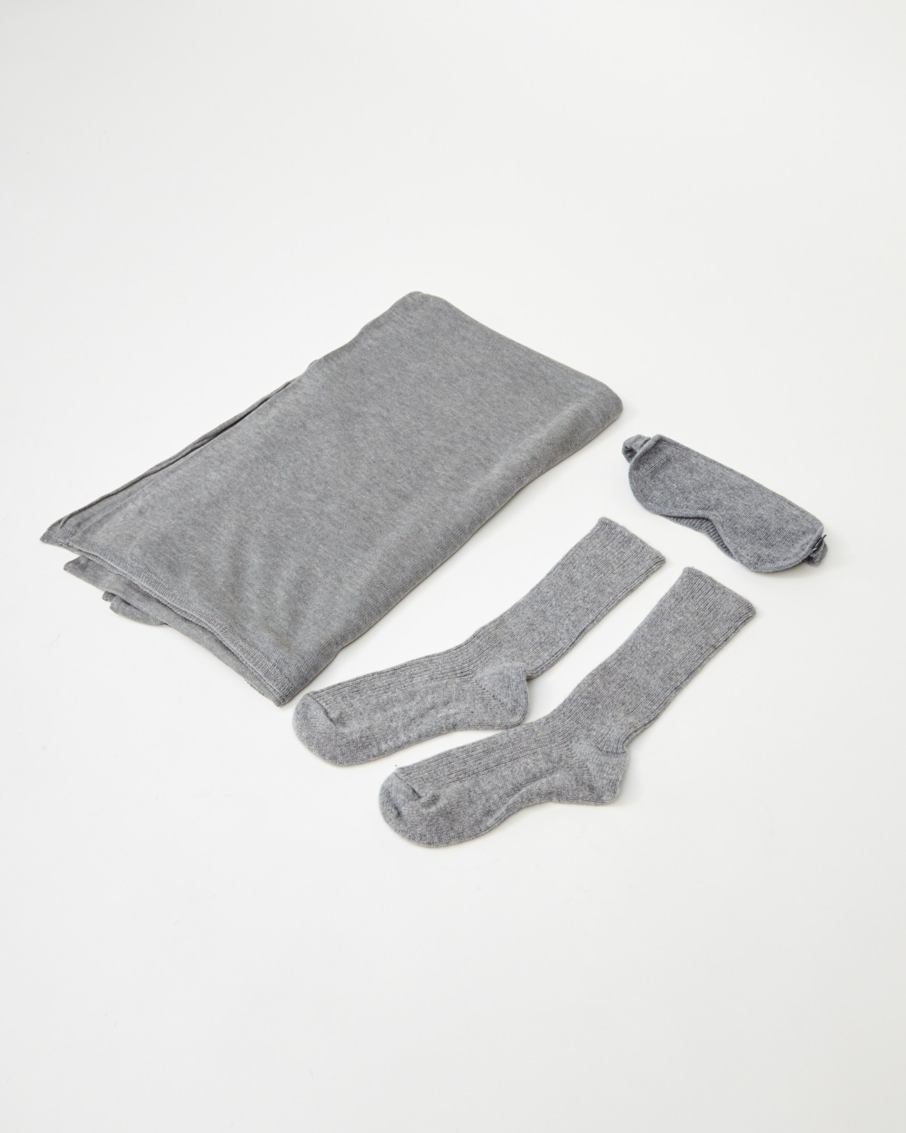 Jac + Jack Travel Wear on-board kit with gray cotton blanket, socks, and eye mask.