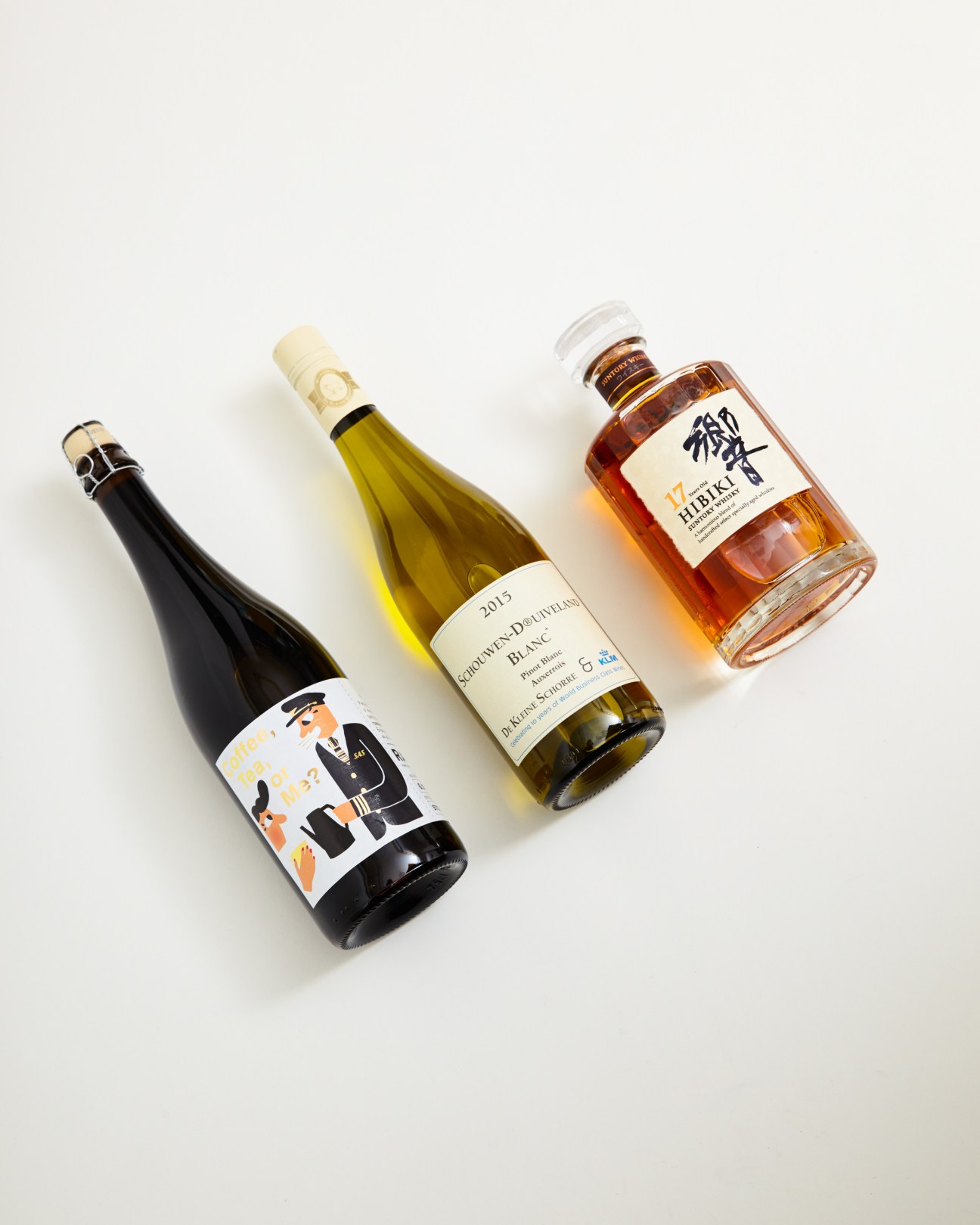 Three bottles displayed: Mikkeller beer, De Kleine Schorre white wine, and Suntory Hibiki whiskey.