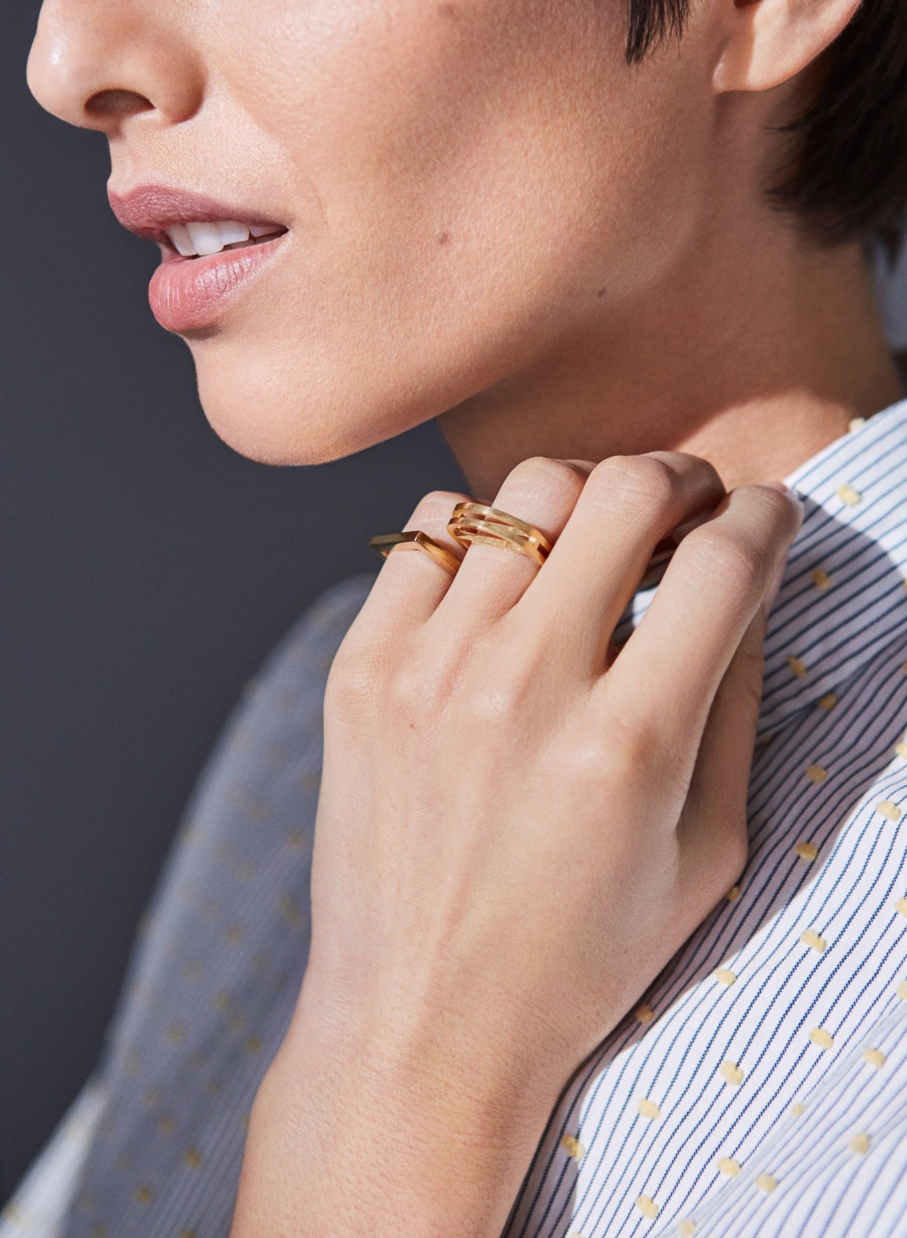 Woman wearing handcrafted gold and silver rings and bracelets