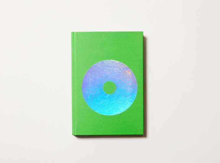 Green hardcover book with gradient blue-to-cyan circular disc design on front cover.