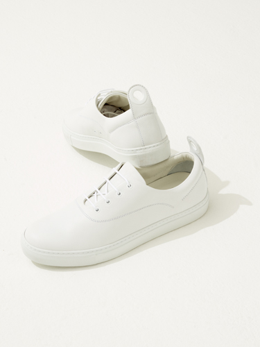 White minimalist unisex leather trainers by Fateeva, crafted from a single cut of leather.