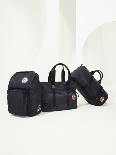 Three black nylon backpacks and tote bags displayed against a white background.