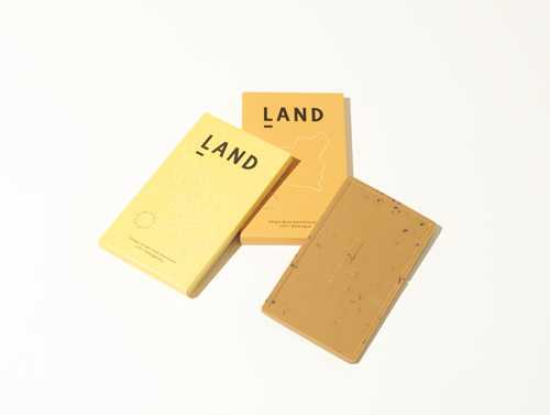 Land chocolate bars in yellow and gold packaging arranged on a light background.