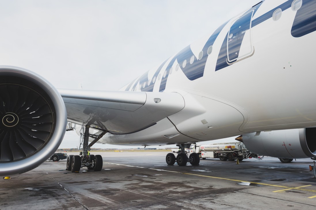 Finnair Airbus A350 aircraft parked at airport with ground service vehicles.