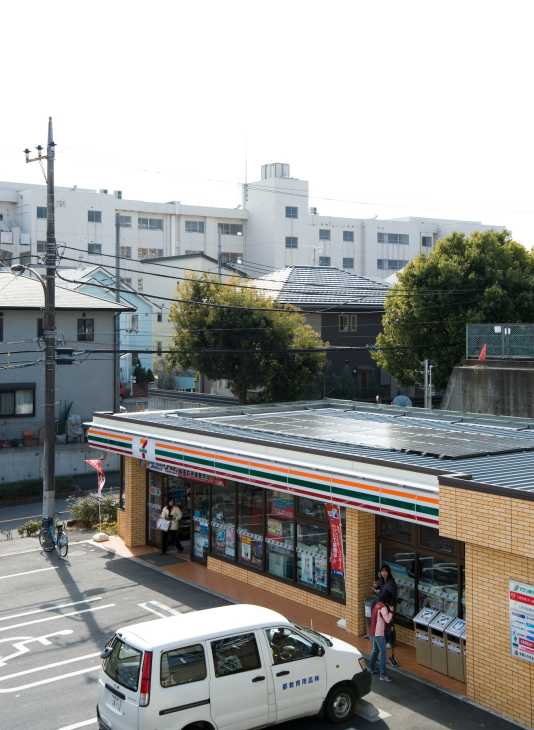 7-Eleven convenience store with solar panels on roof in Kyoto, Japan.