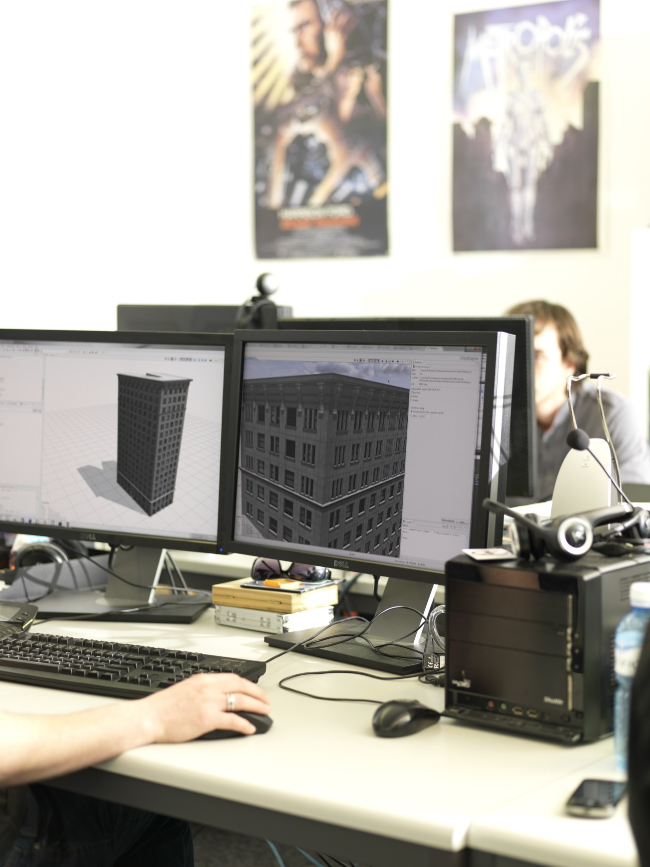 Procedural's 3D modeling software CityEngine displayed on dual computer monitors showing architectural building designs.