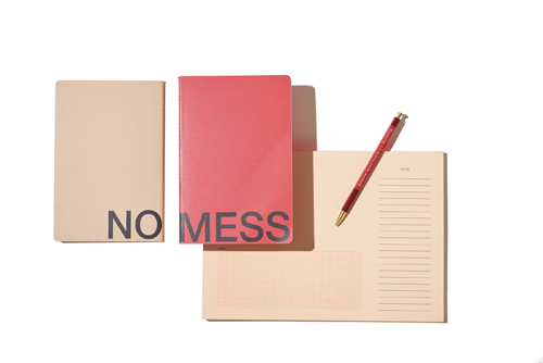 Nomess notebooks in neutral and pink tones with a pen for organizing thoughts and to-do lists.