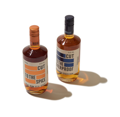 Two bottles of Cut Rum with orange and blue labels on white background.
