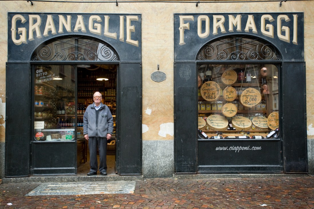 Ciapponi food purveyor storefront in Morbegno, Italy with owner standing in doorway.