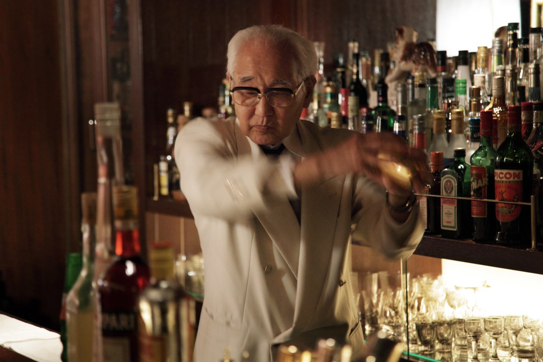 Seasoned bartender Mitsugi Yoshida mixing a cocktail behind the bar at Y&M Bar Kisling in Tokyo's Ginza district.