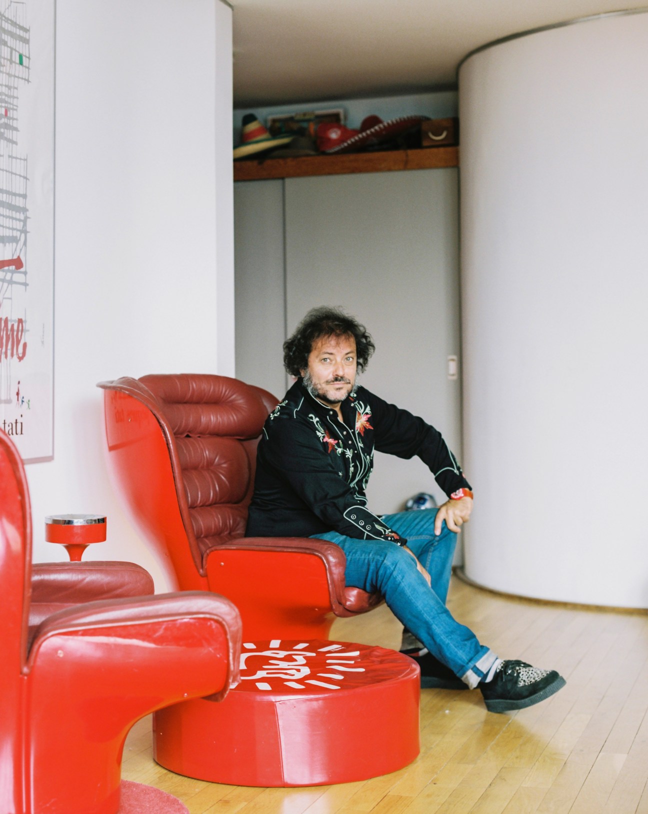 Enrique López Lavigne, a film producer and resident, sits in a red leather chair in his Torres Blancas apartment.