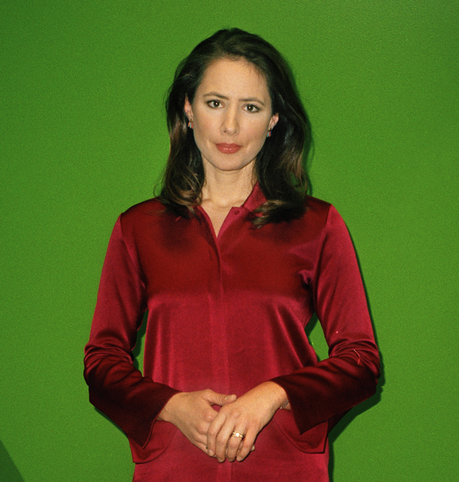 Belle Donati, news anchor at Euronews, wearing a red shirt against a green background.
