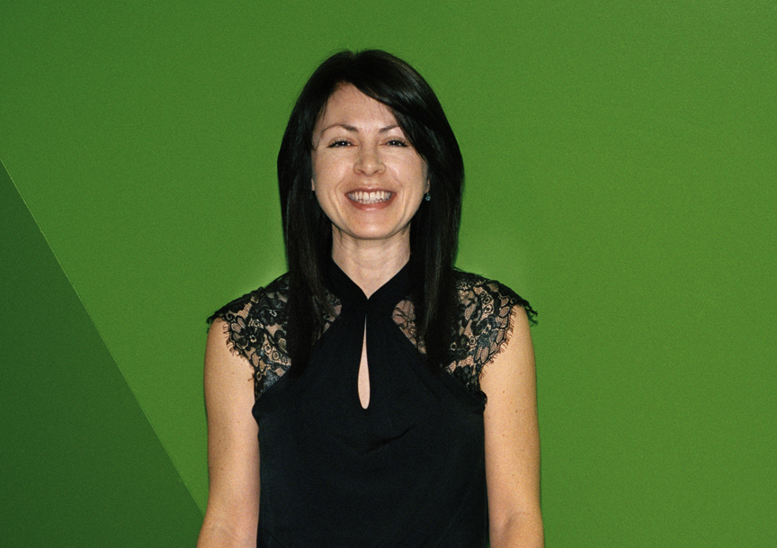 Sarah Taylor, senior producer at Euronews, smiling against a green background.