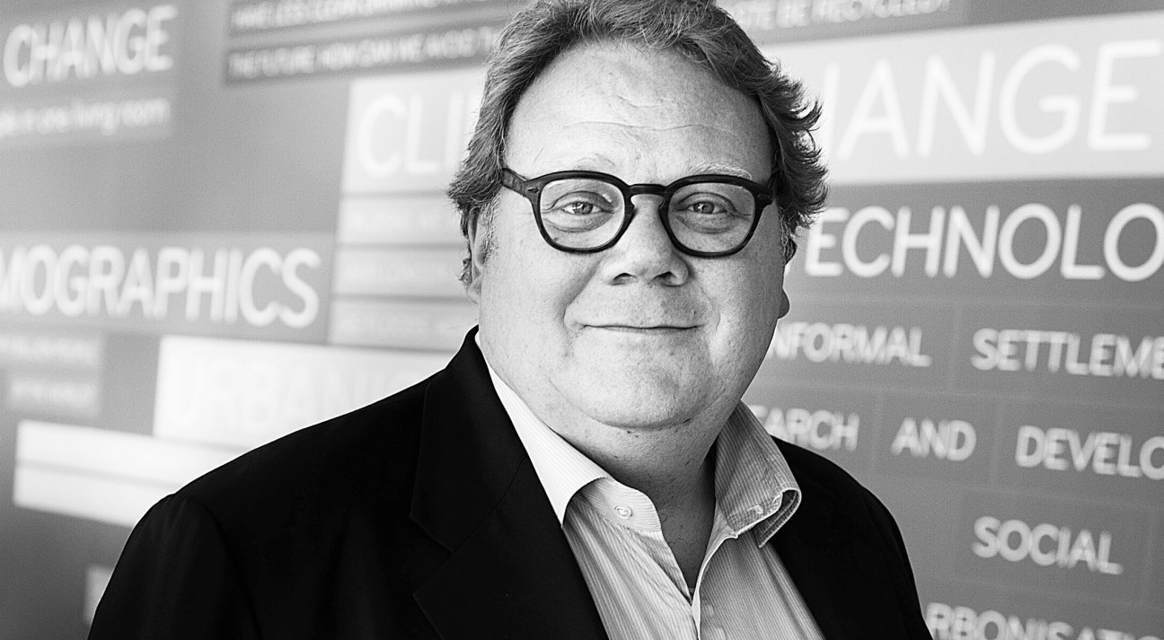 Portrait of Nille Juul-Sørensen, CEO of Danish Design Centre, wearing glasses and dark jacket.