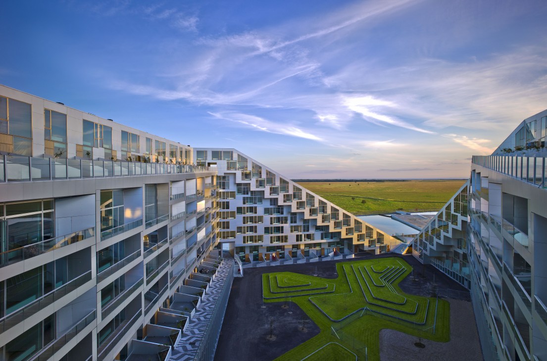 Aerial view of 8 House in Copenhagen showing stepped residential blocks surrounding a central courtyard with green landscaping.