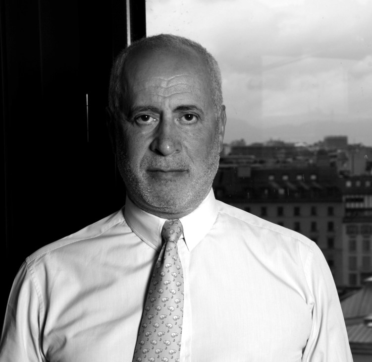 Portrait of Theodore Margellos, managing partner of IJ Partners, wearing a white shirt and patterned tie.