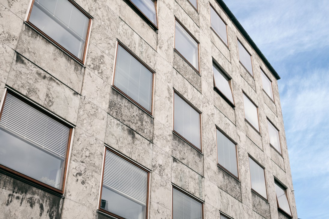 Close-up of Aarhus city hall's Norwegian marble exterior facade with regular window openings.
