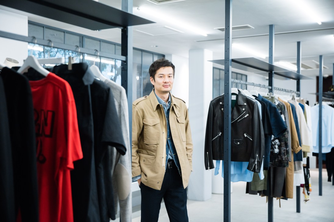 Gaku Sakomura, fashion buyer at Bioto boutique in Tokyo, standing among displayed clothing