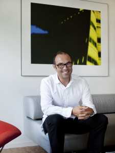Professor Urs Heinberg in his Halen home surrounded by modernist design books