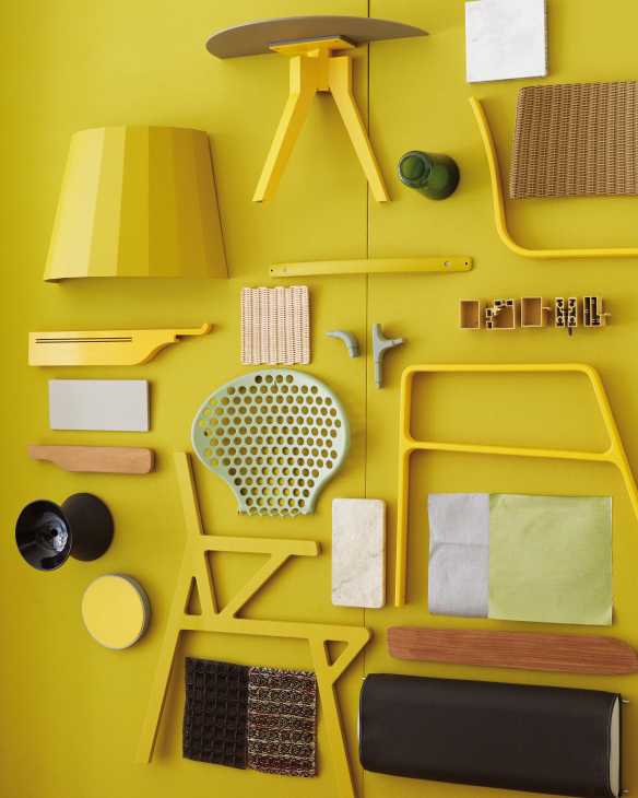 Flat lay of Kettal outdoor furniture components including yellow metal chair frames, woven seat samples, fabric swatches, and hardware on bright yellow background.