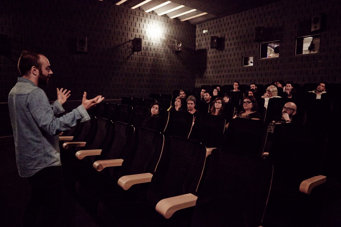 A bearded man speaks to an audience during a Q&A session in Zumzeig cinema's foyer-bistro.