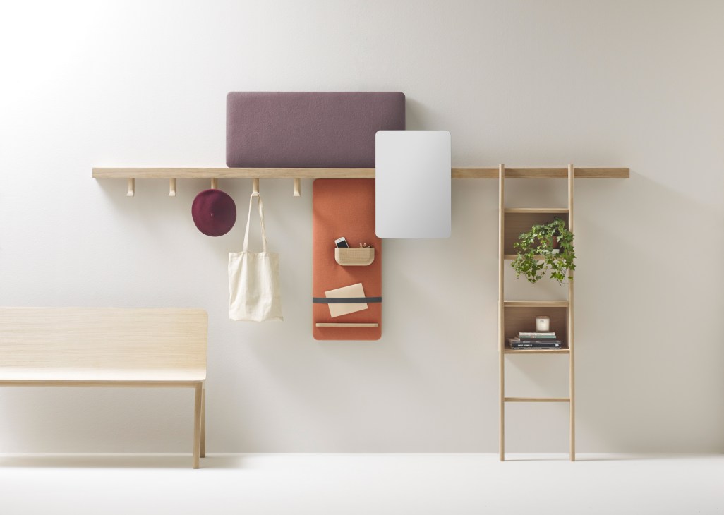 Zutik modular shelf system by Alki featuring adjustable wooden shelves, hanging hooks, mirrors, and storage panels on a white wall.