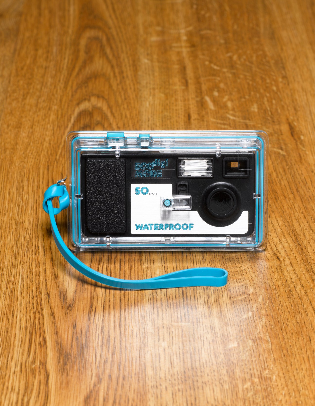 55 Station waterproof digital camera with blue trim and wrist strap on wooden surface