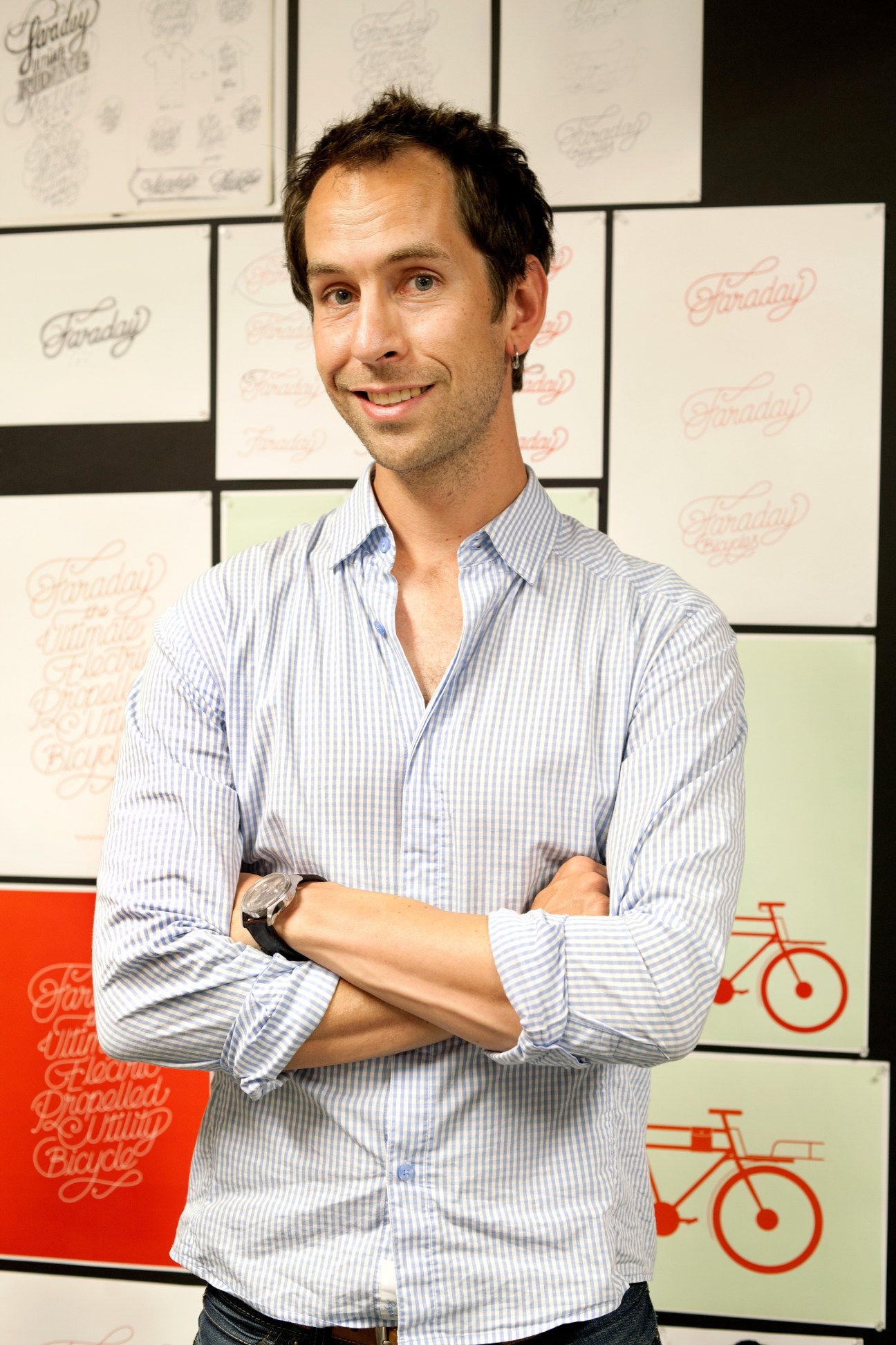 Adam Vollmer, founder of Faraday, stands with arms crossed against a branded backdrop.