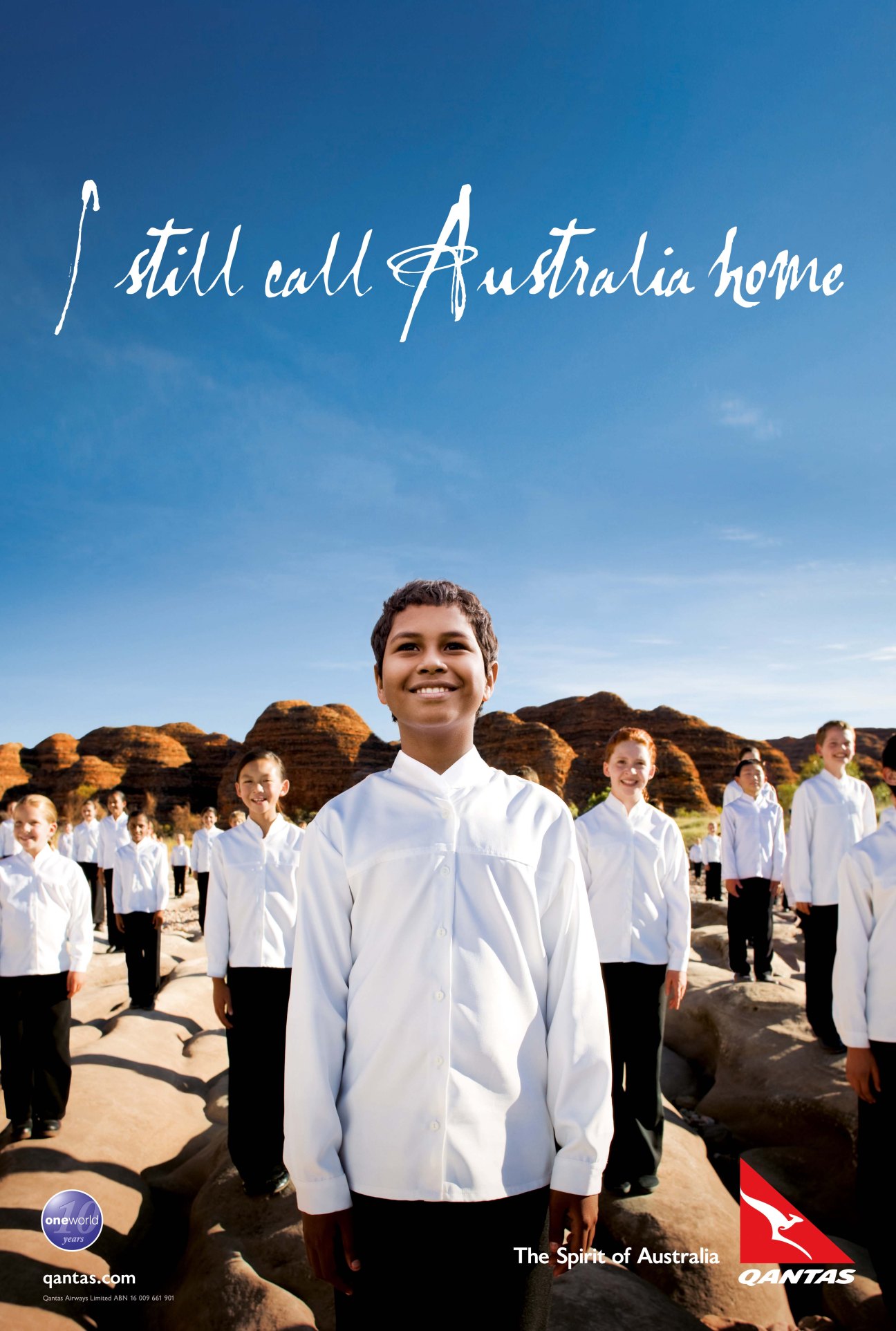 Children in white shirts singing at Purnululu with red rock formations behind them and 'I still call Australia home' text overlay.