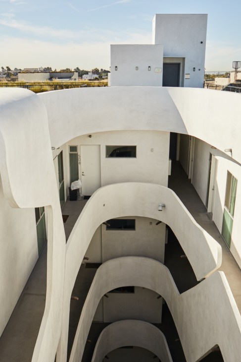 Overhead view of 1038 Mariposa Avenue's elliptical central courtyard with curved white walls and multiple floor levels visible.