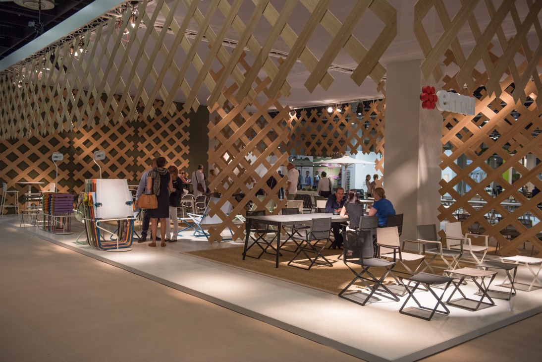 Emu stand at Spoga+Gafa garden fair featuring modern outdoor furniture and latticed wooden display panels.