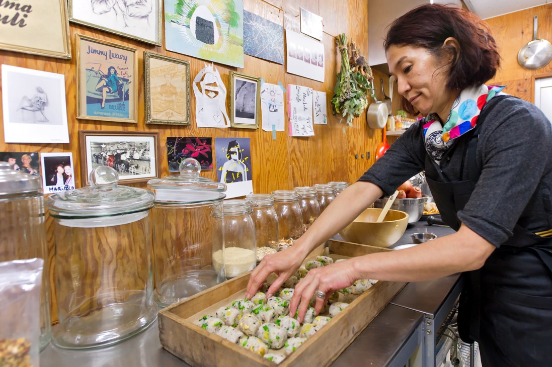 Luli Shioi arranges prepared dumplings in a tray at her Mama Luli catering kitchen in Tokyo.