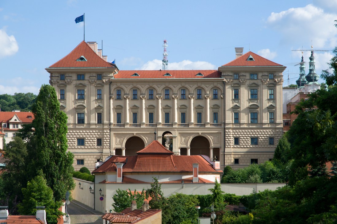 Bratislava Castle with EU flag, baroque architecture and red-tiled roofs overlooking the city.
