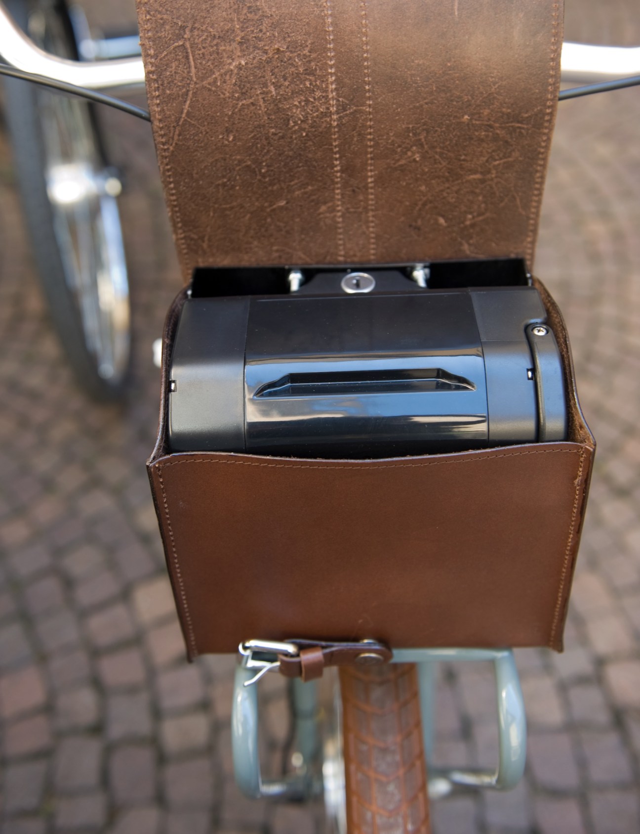 Hand-stitched leather pouch on Velorapida e-bike containing the battery pack.