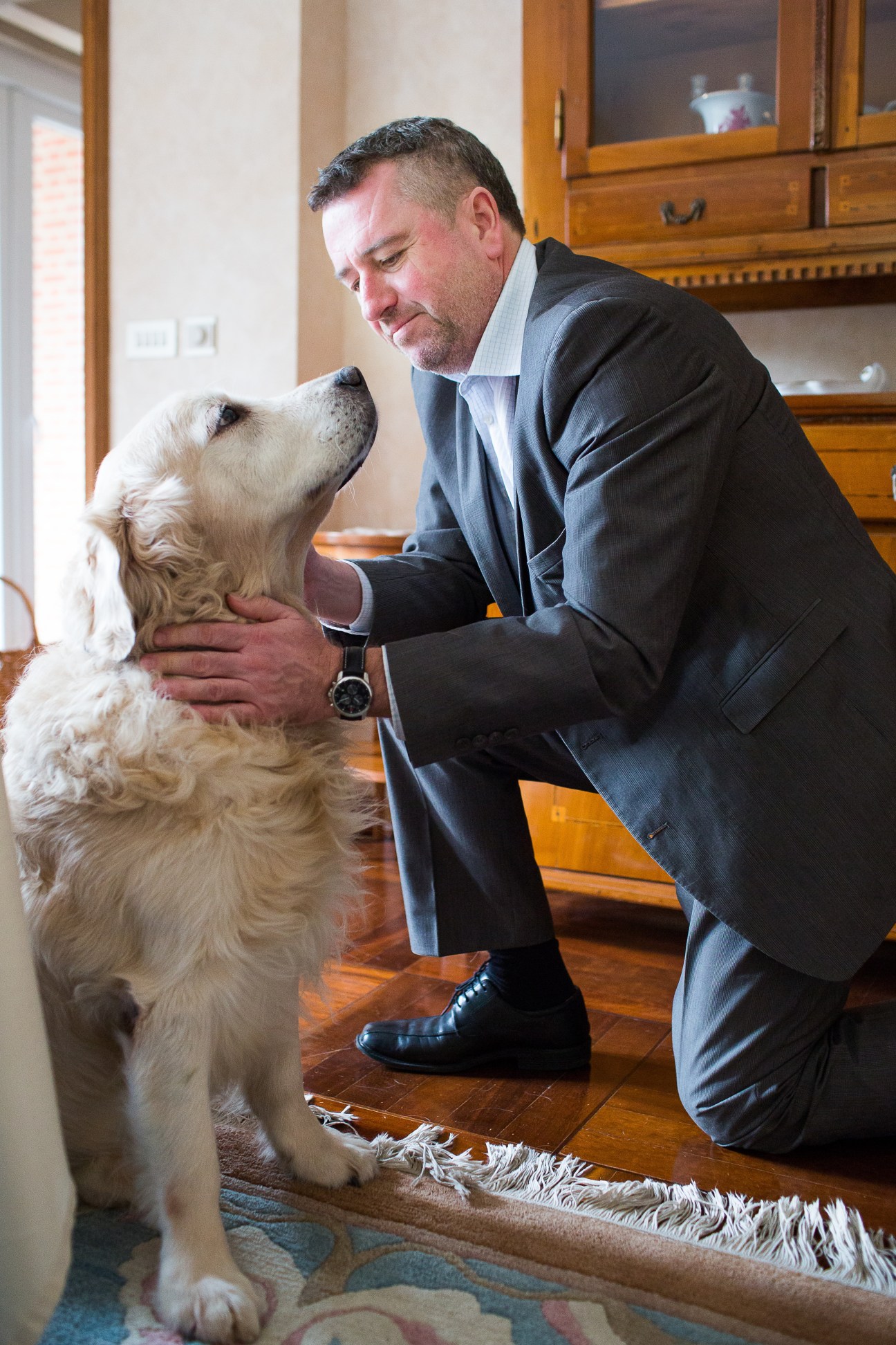 Péter Györkös, Hungary's ambassador to the EU, interacts with his golden retriever Füles indoors.