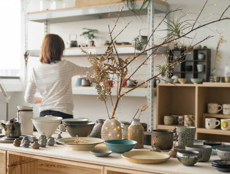 Hotel & Home Singapore showroom displaying contemporary porcelain pieces and ceramics on a wooden table.