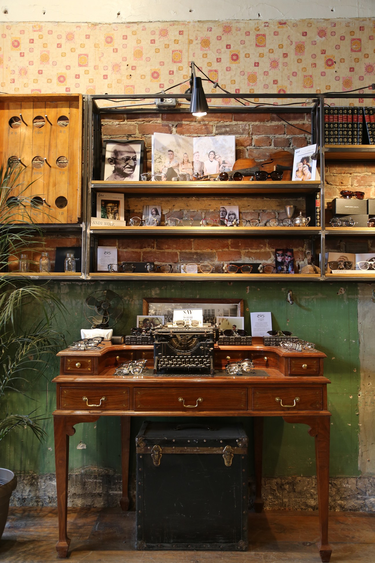 Interior of Voskins optometry shop in Montreal showing wooden desk with typewriter and vintage frames display.