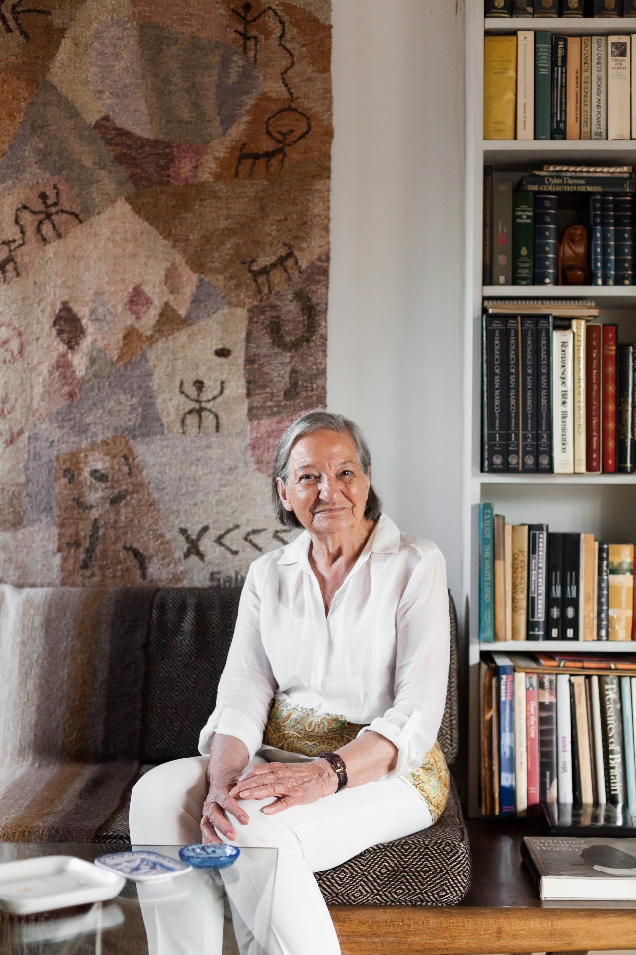 Celia Pozzi, a 90-year-old retired literature professor, sits in her Los Eucaliptos penthouse apartment surrounded by bookshelves.
