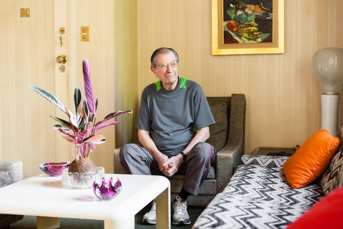Jose Maria Gonzalez sits in his modernist apartment at Los Eucaliptos with period furniture and architectural details visible.
