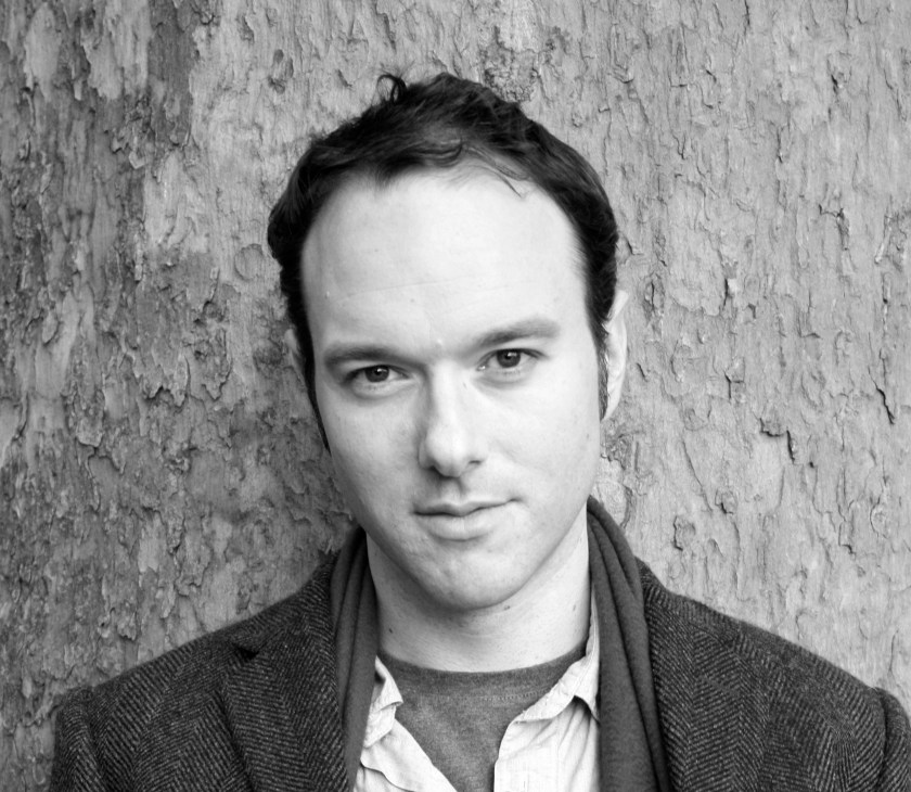 Black and white portrait of a man against a textured wall background