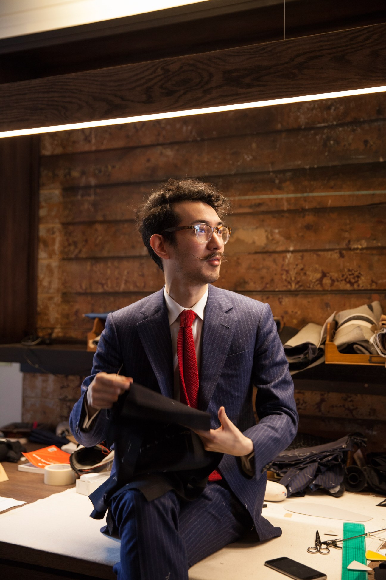Traditional English tailor shop interior with cutting table
