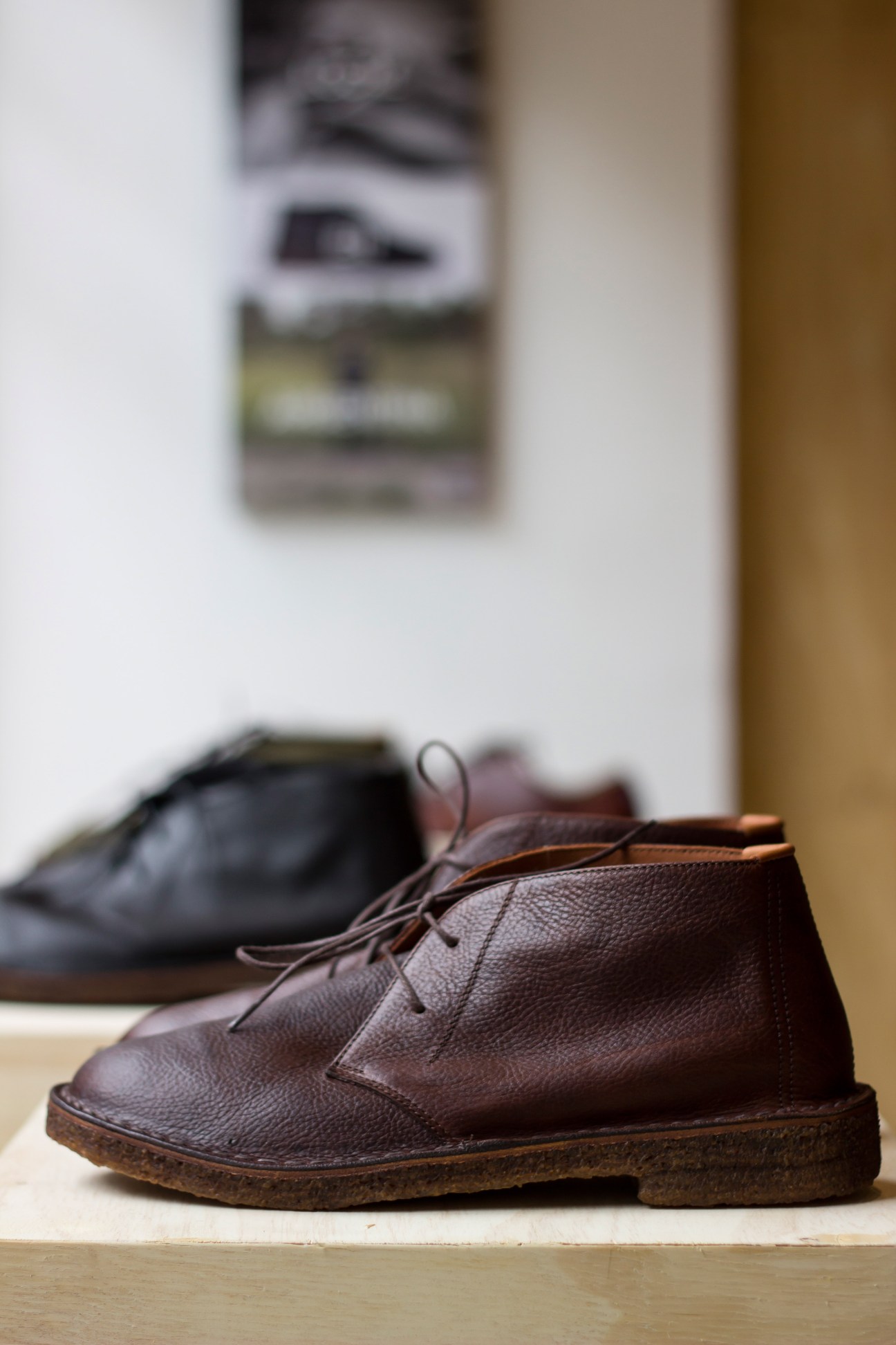 Posco handcrafted leather desert boots with distinctive rubber soles displayed on wooden surface