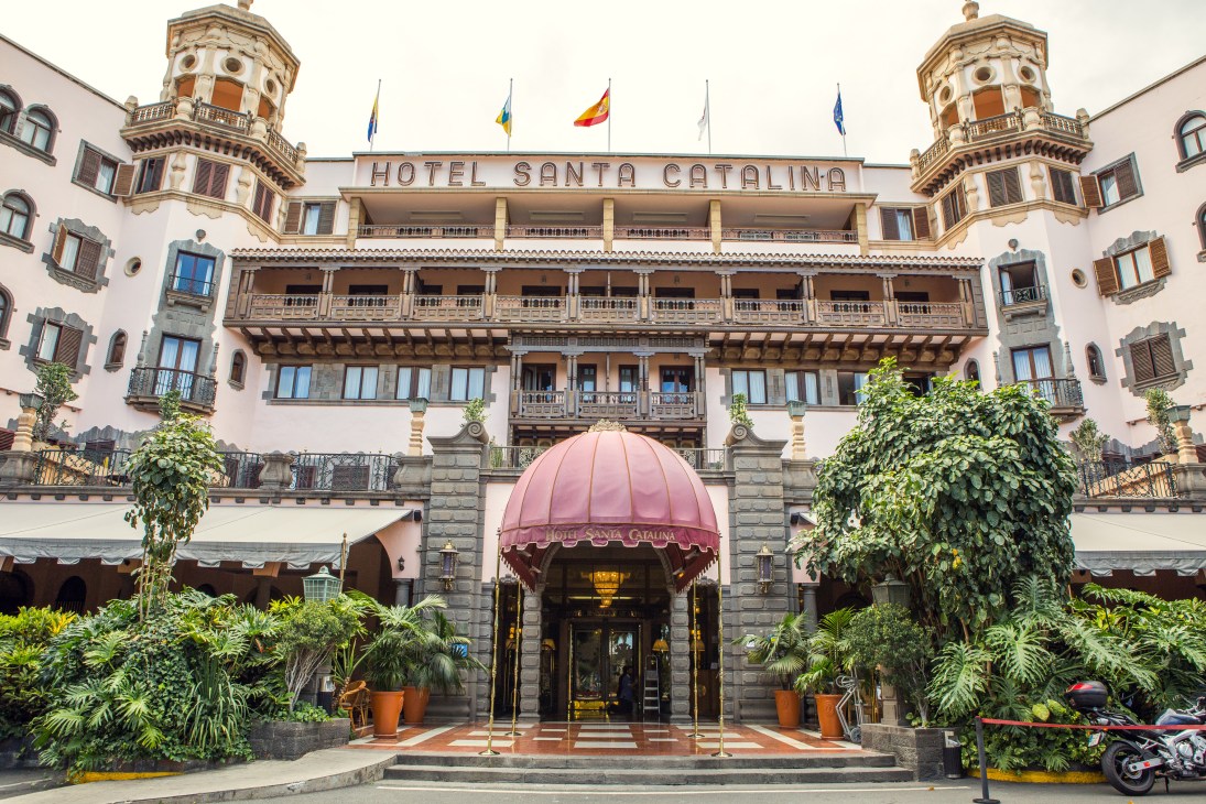 Hotel Santa Catalina's grand colonial facade with twin towers and pink entrance awning in Las Palmas.