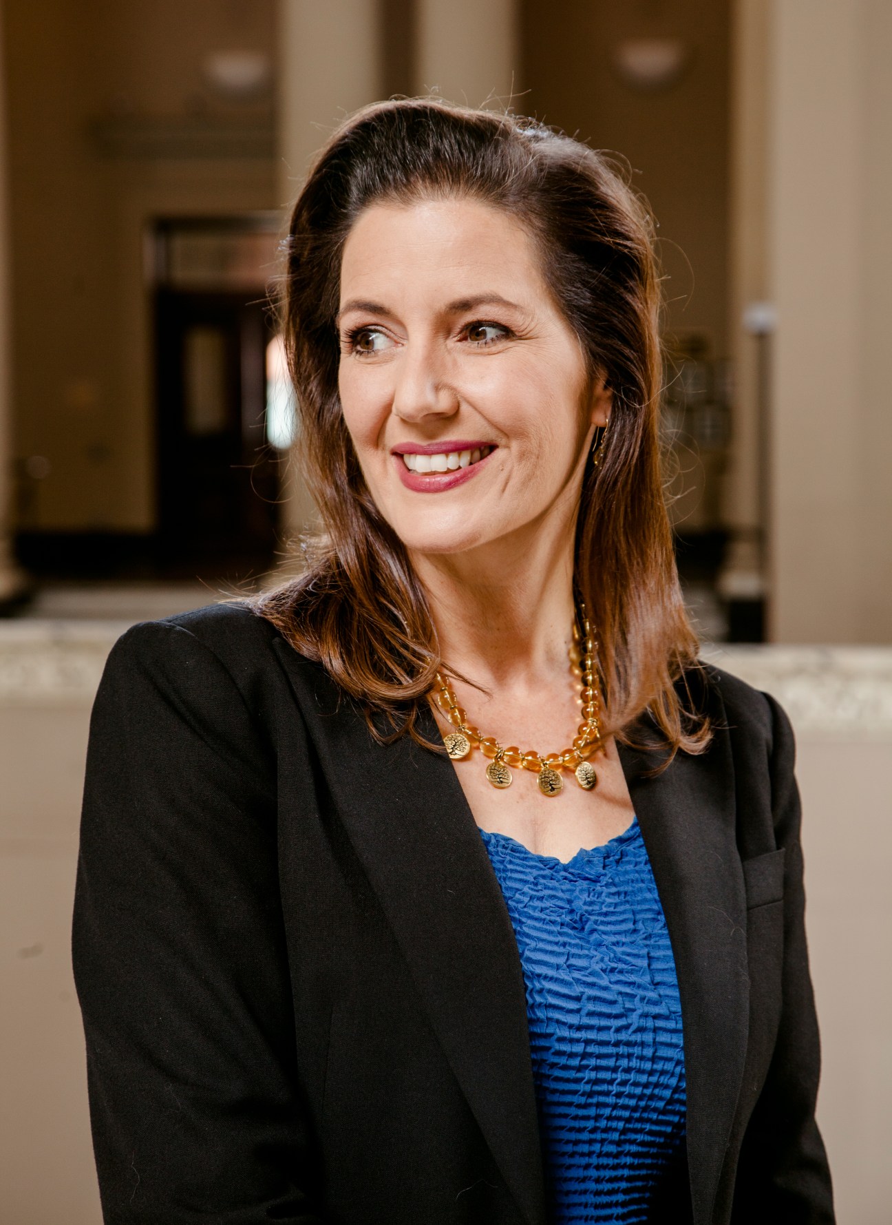 Portrait of Libby Schaaf, Mayor of Oakland, smiling in a professional black blazer and blue top.