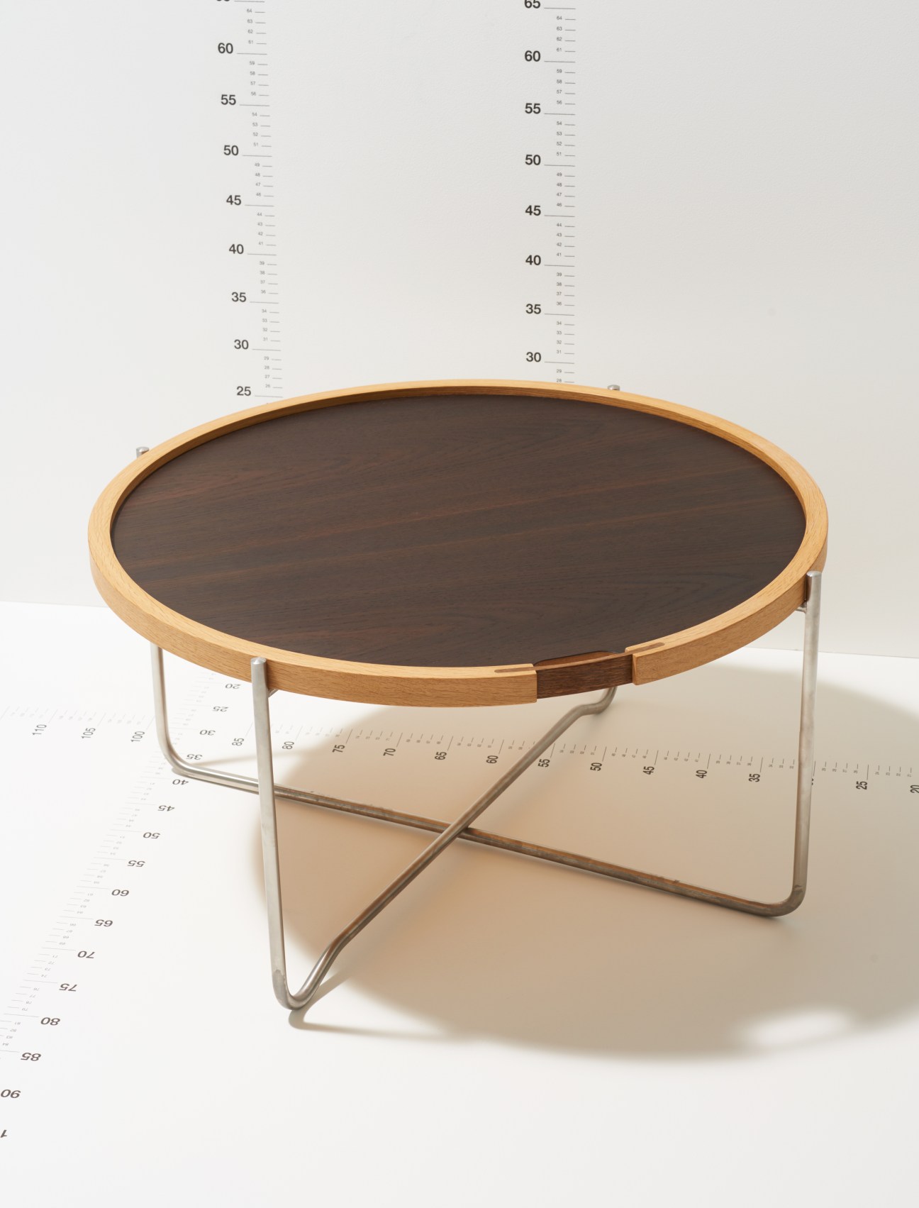 Reversible tray and coffee table by Carl Hansen & Søn with wooden frame and dark top on metal base.