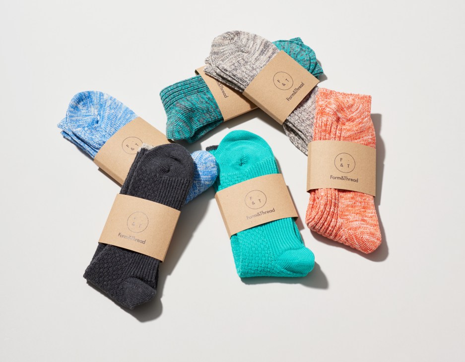 Colorful Form & Thread socks in blue, teal, gray, coral and black displayed with kraft paper bands.