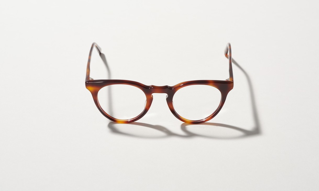 Tortoiseshell acetate eyeglasses with round frames on white background