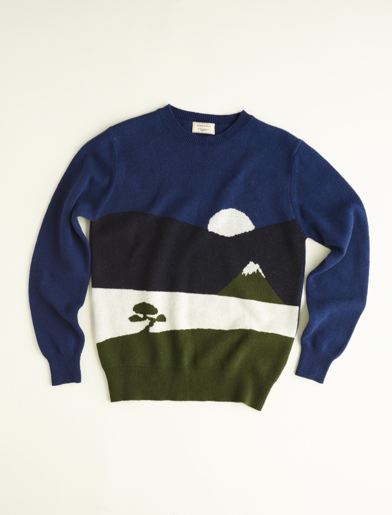 Navy blue wool jumper with intarsia knit design featuring snowy mountains and a tree in black, white and olive green.